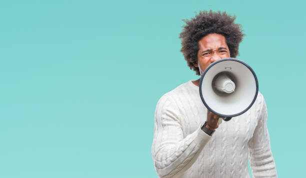 istock Young handsome afro american black man shouting through megaphone 1097964314