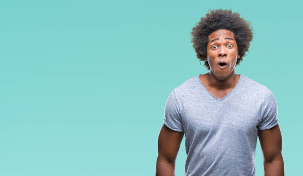 istock Afro american man over isolated background afraid and shocked with surprise expression, fear and excited face. 1097967146
