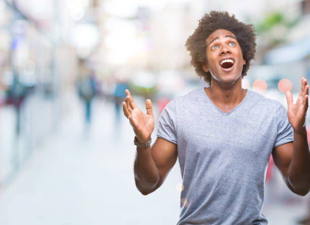 istock Afro american man over isolated background crazy and mad shouting and yelling with aggressive expression and arms raised. Frustration concept. 1097970544