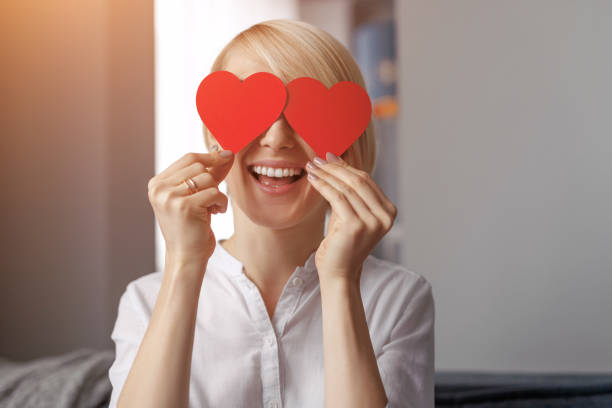 istock Cheerful woman with hearts near eyes 1097970708