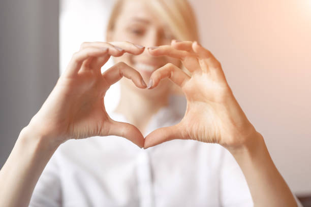 istock Blurred woman showing hand heart gesture 1097970710