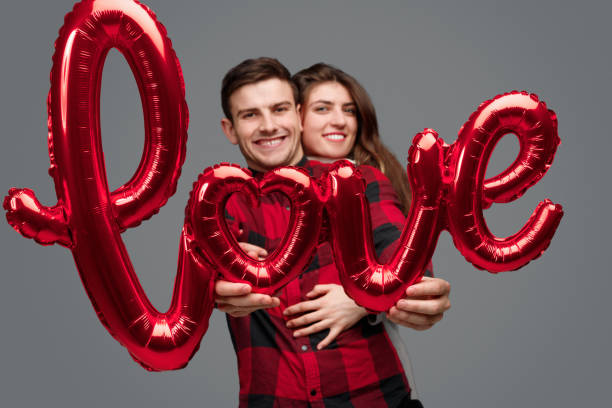 istock Cheerful woman hugging man with love writing 1097970834