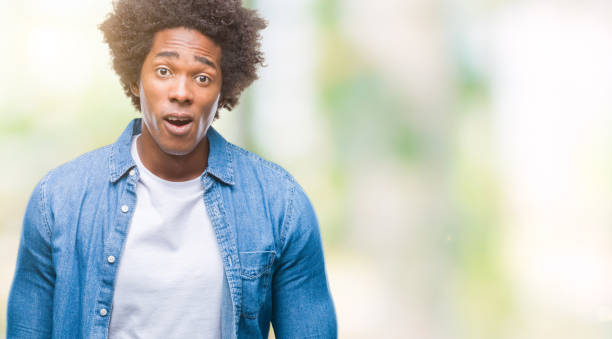 istock Afro american man over isolated background afraid and shocked with surprise expression, fear and excited face. 1097971146