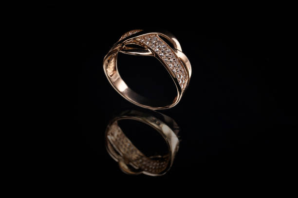 Precious gold ring with stones and reflection on glass