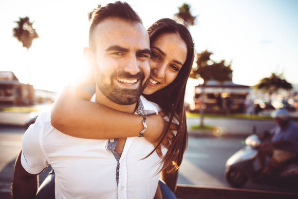 istock piggybacking couple at dusk on vacation 1097974498