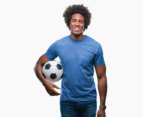 Afro american man holding football ball over isolated background with a happy face standing and smiling with a confident smile showing teeth