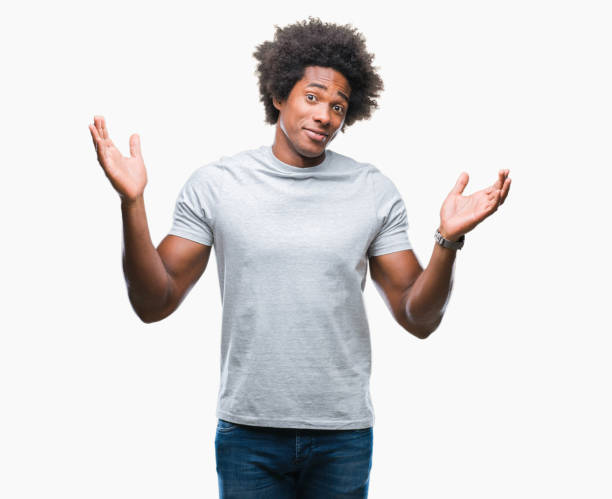 istock Afro american man over isolated background clueless and confused expression with arms and hands raised. Doubt concept. 1097975680