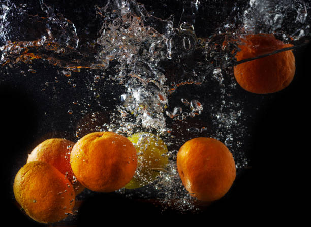istock fresh lemon and tangerines in water splash on black background 1097976146