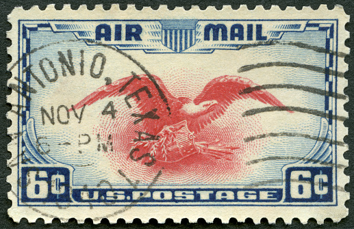 Postage stamp printed in the USA shows Eagle Holding Shield, Olive Branch and Arrows in 1937