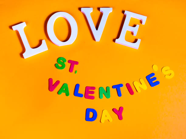 istock Word love in white and also colored words valentine's day over orange background 1097977962