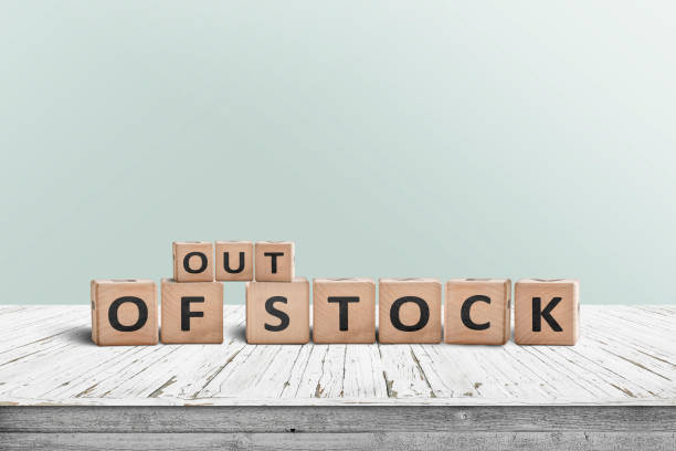Out of stock sign standing on a wooden table stock photo