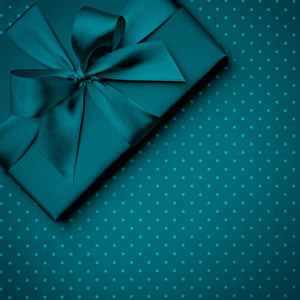 istock Dark turquoise gift box flat lay on dark turquoise background. Concept present box decoration holiday top view. Copy Space 1097980698