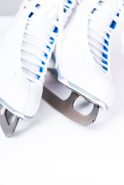 istock New white figure skates on a white background. 1097983146