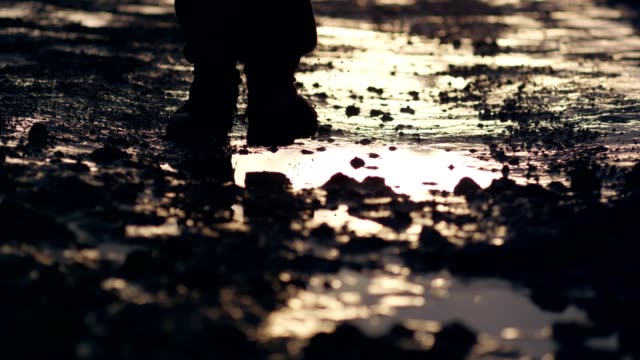 Polish martial law 1981. Socialist militiaman reflecting in puddle. Sunset