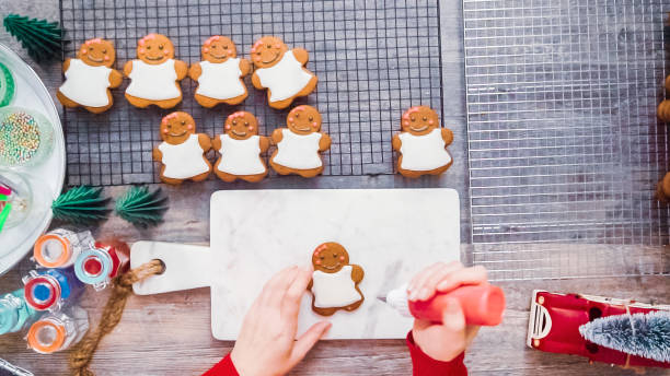 istock Decorating gingerbread cookies with royal icing. 1097985566