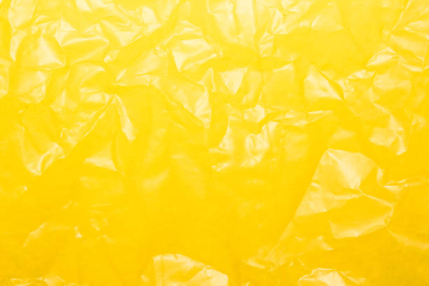 Wrinkled yellow plastic sheet for background or text.