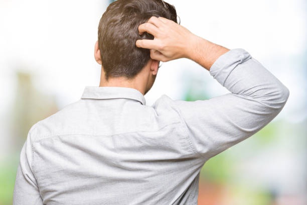 istock Young handsome man wearing glasses over isolated background Backwards thinking about doubt with hand on head 1097989622