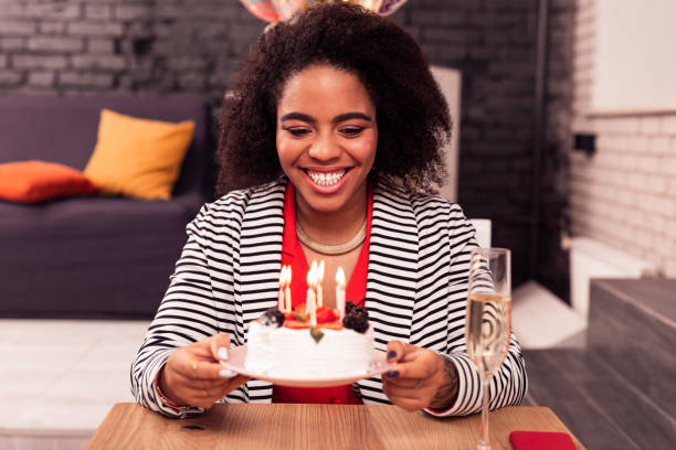 istock Joyful attractive woman holding a plate with cake 1097992620