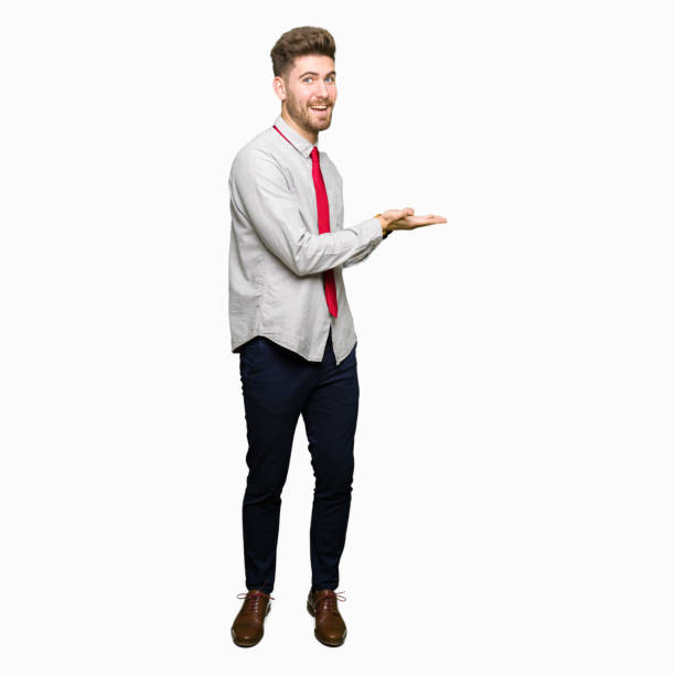 istock Young handsome business man Pointing to the side with hand and open palm, presenting ad smiling happy and confident 1097999110