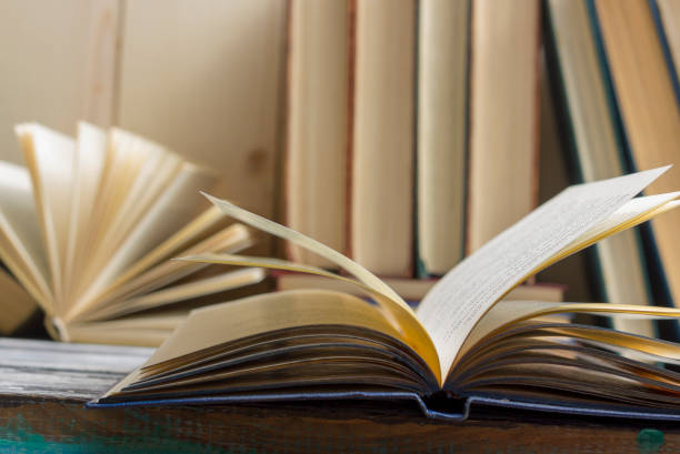 istock Open book, hardback books on wooden table. Back to school. Copy space 1097999382