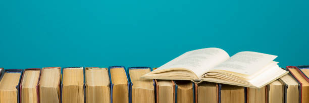 istock Open book, hardback books on wooden table. Back to school. Copy space 1097999552