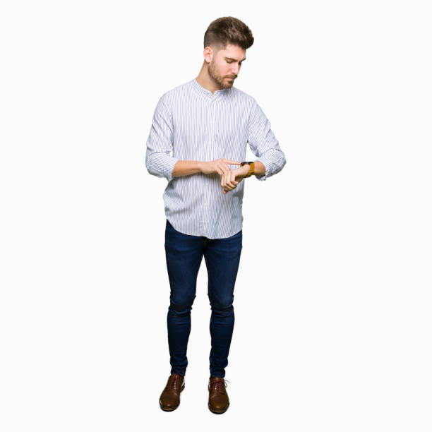 istock Young handsome man Checking the time on wrist watch, relaxed and confident 1097999632
