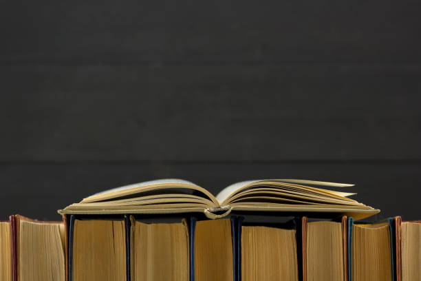 istock Open book, hardback books on wooden table. Back to school. Copy space 1097999644