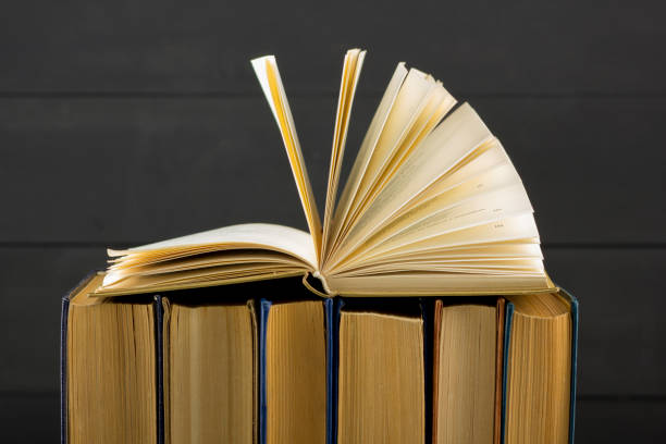 istock Open book, hardback books on wooden table. Back to school. Copy space 1097999668