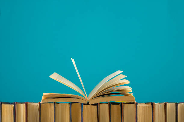 istock Open book, hardback books on wooden table. Back to school. Copy space 1097999758