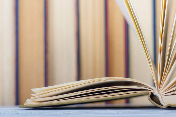 istock Open book, hardback books on wooden table. Back to school. Copy space 1097999966