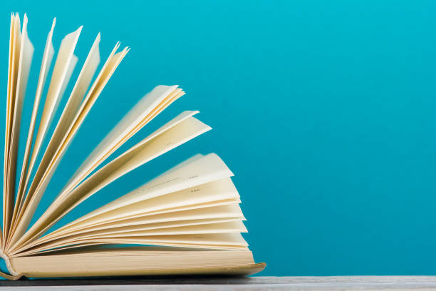 istock Open book, hardback books on wooden table. Back to school. Copy space 1097999974