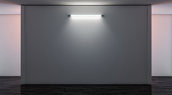 Blank white gallery wall with lamp in darkness mockup, front view, 3d rendering. Empty museum illuminated canvas mock up. Clear large glowing display for exibition or artwork template.