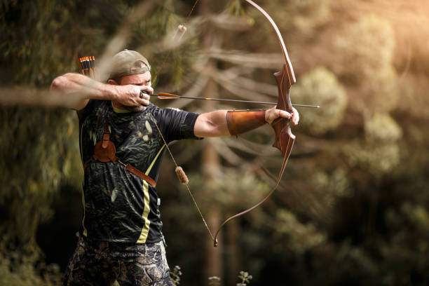 istock Strong archer firing arrow 1098003736