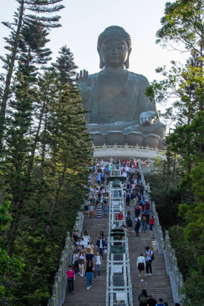 People climbing stairs to the seated, bronze, Tian Tan Buddha, Hong Kong, China stock photo