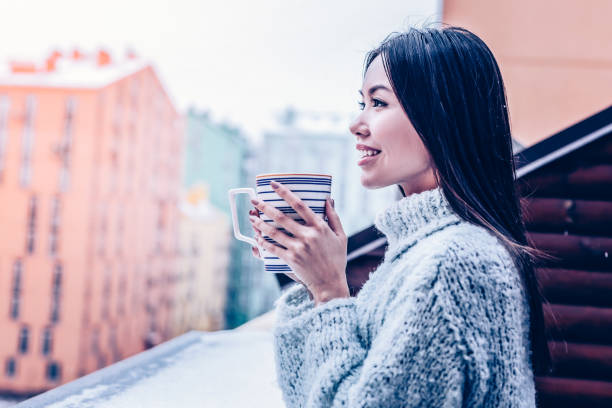 istock Nice happy woman standing with a cup of tea 1098011726