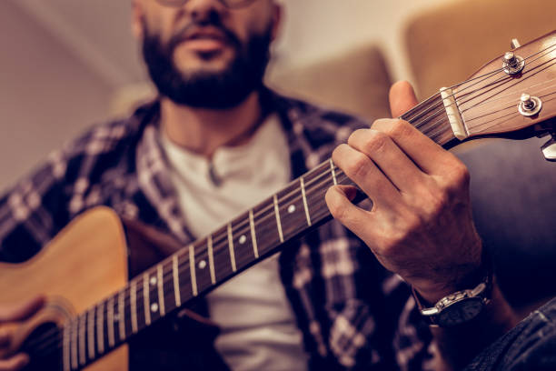 istock Selective focus of male fingers touching strings 1098011960