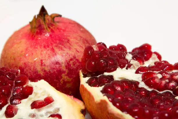 Photo of Purified pomegranate fruit on a white background