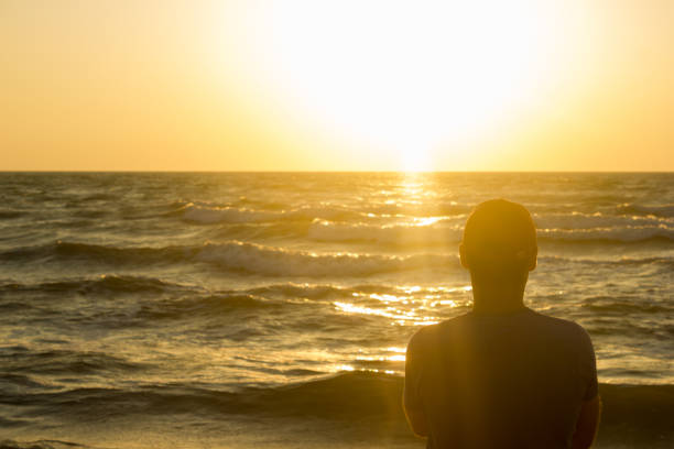 istock Portrait of a young man in cap on the beach 1098017832