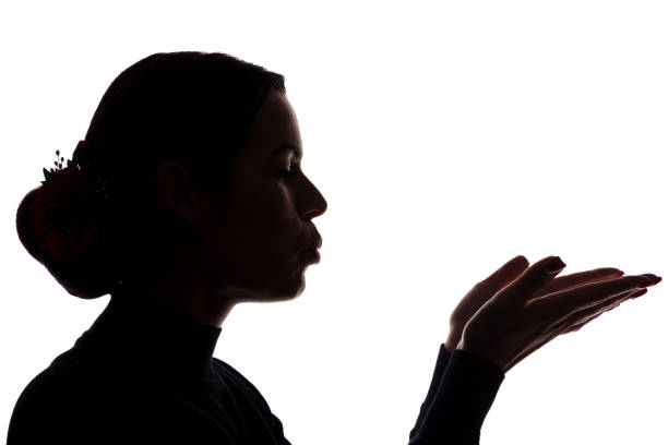 istock Young woman shows his hands forward, sending a kiss 1098017888