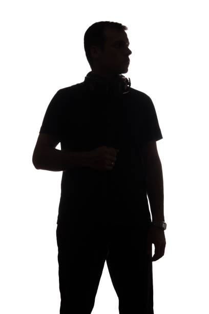 istock Silhouette young man with a smartphone with headphones 1098017976