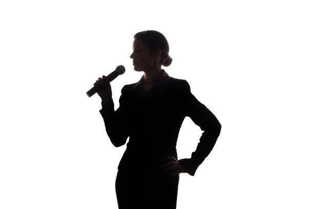 istock Young woman singing into the microphone 1098018014