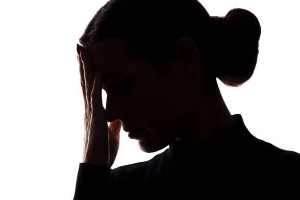 istock Silhouette of a young woman keep her head 1098019274