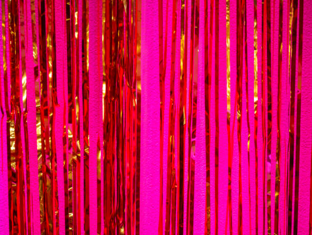 istock Gold ribbons on a pink background. 1098020912