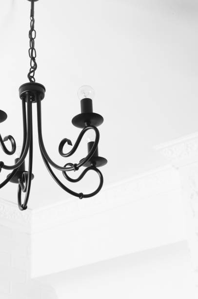 istock Black chandelier in white interior 1098021604