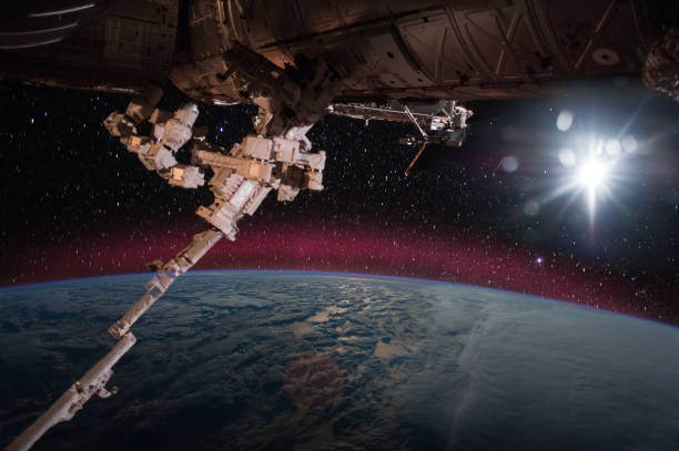 istock Spaceship on the orbit. Earth with clouds sunshine on the background. Elements of this image furnished by NASA. 1098021842