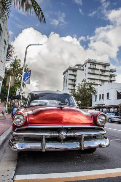 istock red classic car with a cloudy sky in Miami Florida 1098031420