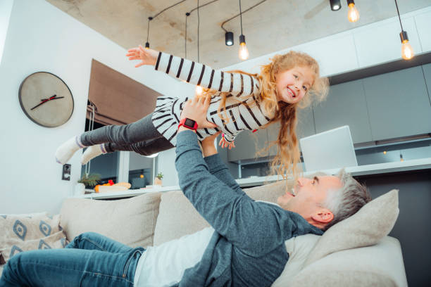 istock Cute small daughter with long hair looking amused 1098031686