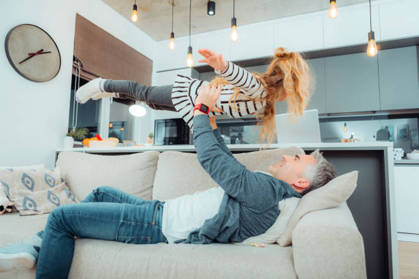 istock Handsome grey-haired father spending time with his cute daughter 1098031710