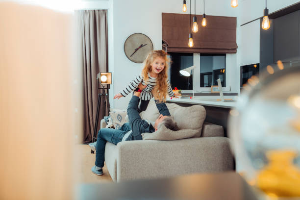 istock Pretty small daughter in a striped sweater smiling nicely 1098031718