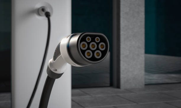 istock Close up of EV charging plug in a city environment close up 3d rendering 1098033512